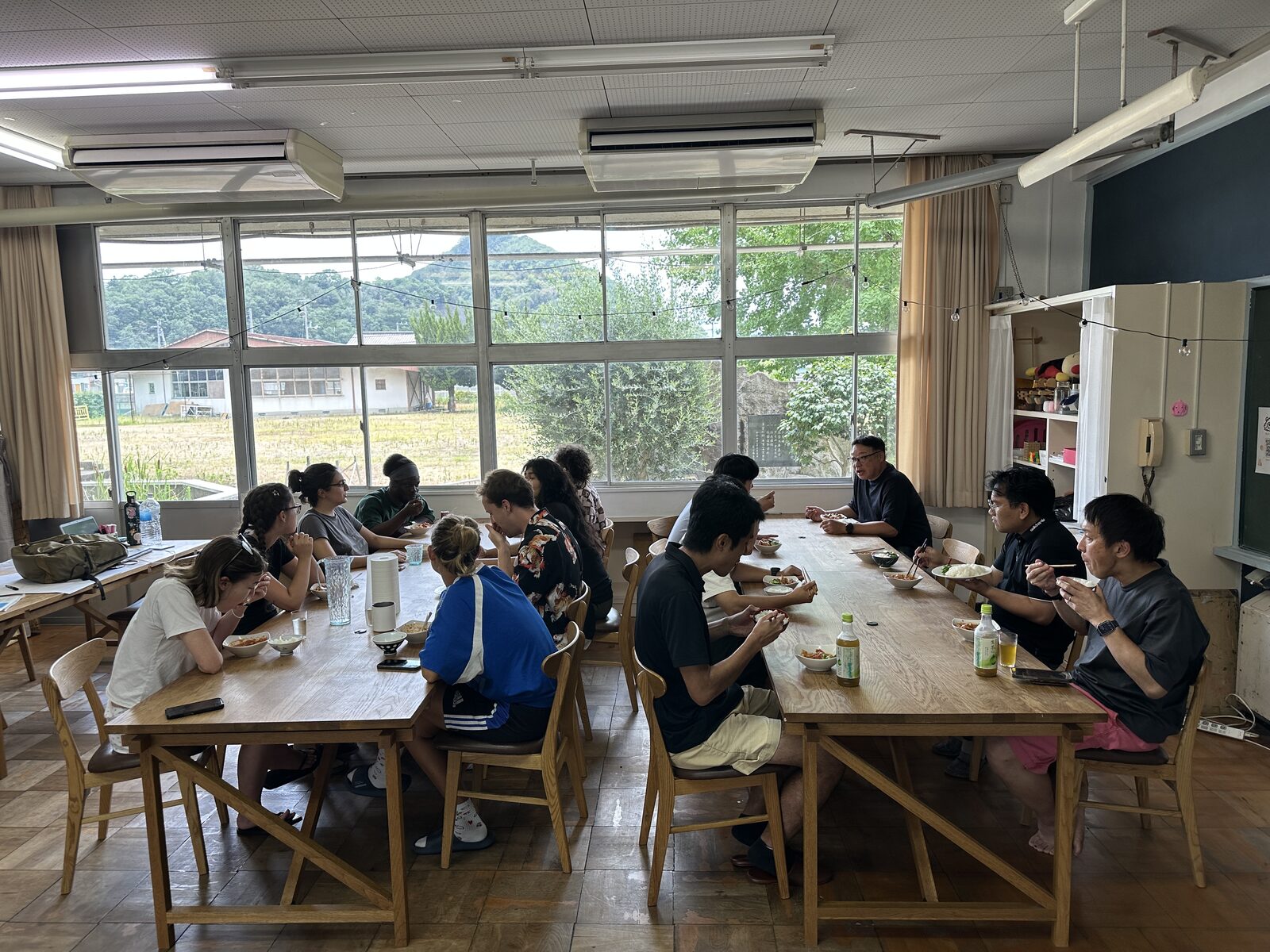 Participants working around wooden tables in the classroom
